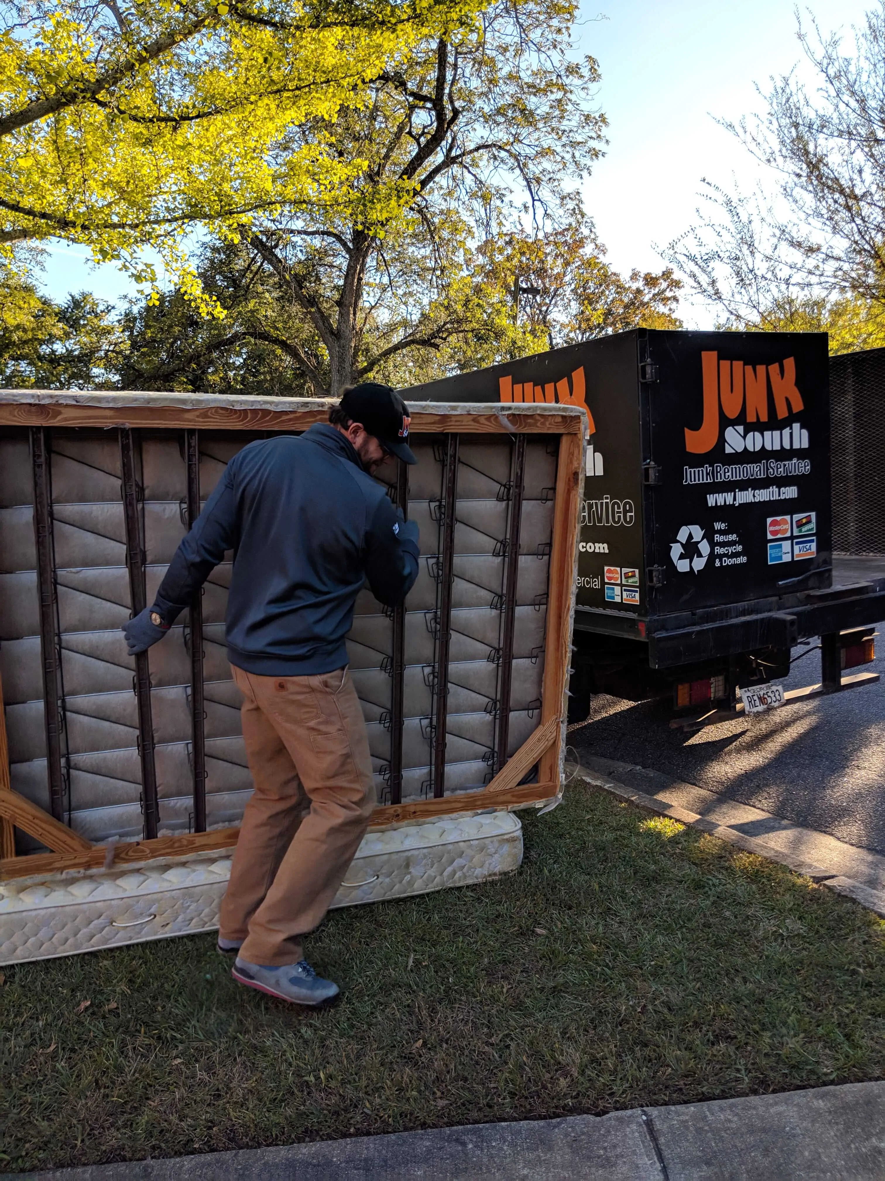 Junk South carries mattress and boxspring to truck